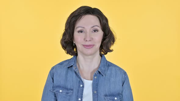 Yes, Old Woman Shaking Head on Yellow Background 