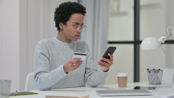 African Woman Excited By Successful Online Shopping on Smartphone