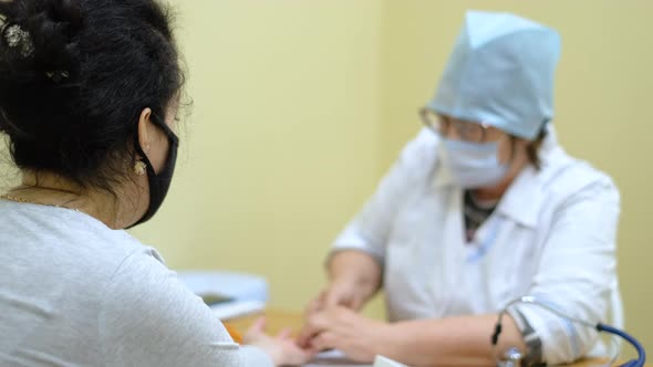 Patient Gets Her Oxygen Saturation Measured By Covid Nurse with Oximeter Device