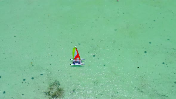 Aerial view around a small catamaran in shallow, turquoise sea, in Dominican republic - circling, dr