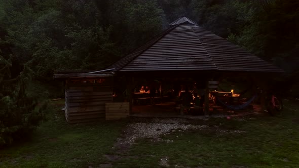 Aerial view of a wooden open hut with people enjoying the night in Soca river.