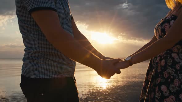 Couple Holding Hands at Sunset