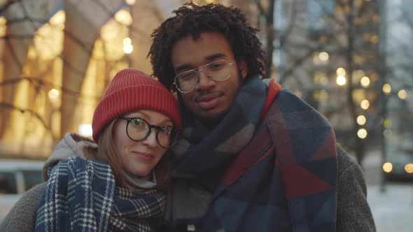 Portrait of Romantic Multiethnic Couple Outdoors in Evening