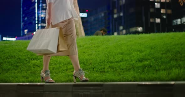 Slow Motion  Shopping Bags, Fashionable Modern Shoes and Silk Skirt in Park