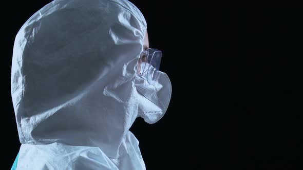 Woman in Uniform Preparing Syringe With Dangerous Virus, Biological Weapons