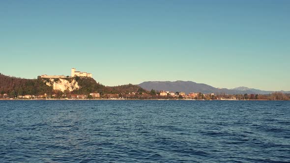 Zoom out view of Angera fortress on lake Maggiore hill, Italy