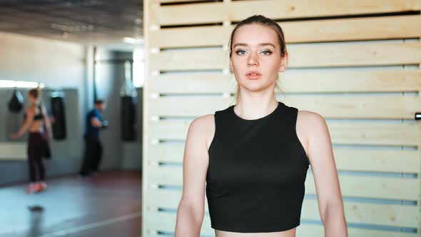 Fitness Girl Lifting Dumbbell in the Gym