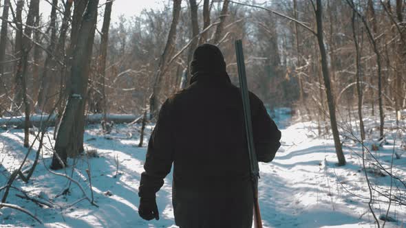 Hunting Hunter Men with Gun Walking Through the Forest During the Hunting Season.