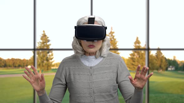 Mature Woman Wearing Virtual Reality Glasses.