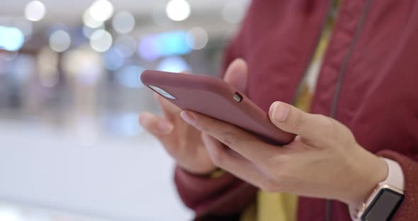 Woman use of smart phone in shopping center