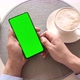 Man holding smartphone with vertical green screen and touch on screen. - VideoHive Item for Sale