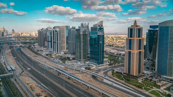 Aerial View of Dubai Marina Skyscrapers and Jumeirah Lakes Towers Timelapse with Traffic on Sheikh