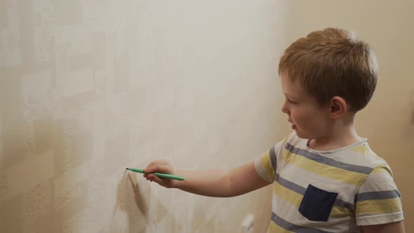 Caucasian Child Draws Marker on Wallpaper