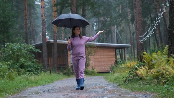 Smiling Woman Enjoying Walking in the Rain