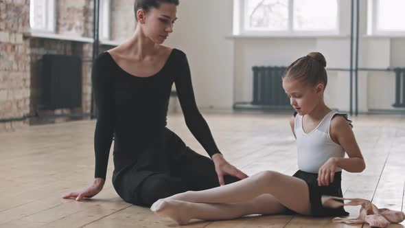 Ballet Trainer And Little Girl Talking After Class