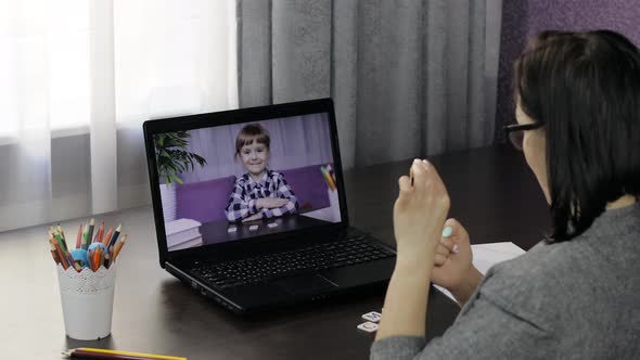 Woman Teacher Makes Video Call on Laptop with Children Pupil. Distance Education