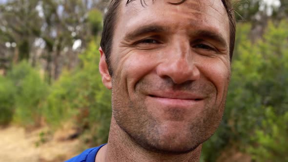 Portrait of fit man smiling during obstacle course