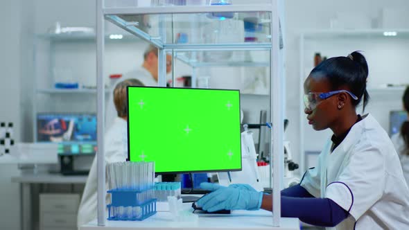 Black Woman Researcher Looking at Chroma Key Computer in Lab