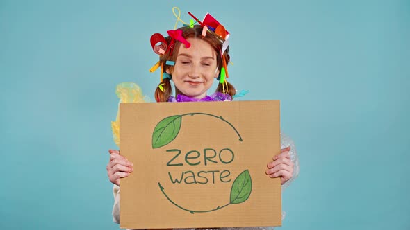 Girl holding cardboard placard with inscription zero waste.