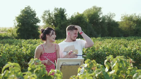 The Artists' Couple Shows Into the Distance Talks and Rejoices in Green Field