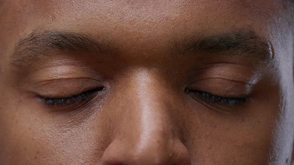 African American Person Blinking in Front of Camera