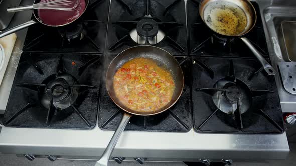 Asian Dish with Mixed Vegetables Cooking on Hot Stove in Restaurant Kitchen