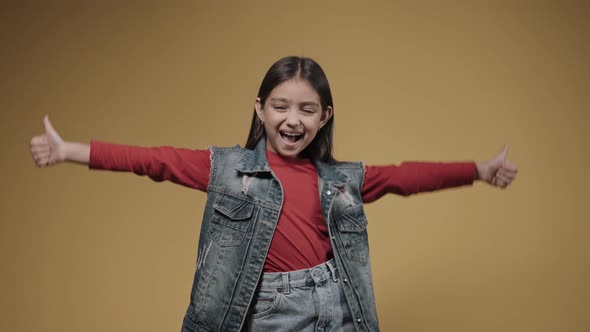 Portrait of Little Girl Giving Thumbs Up to the Sides Smiling Happy Emotions