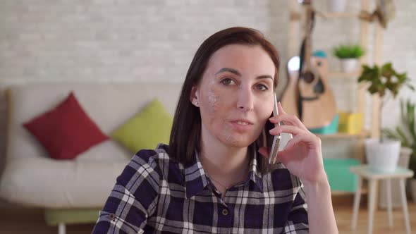 Portrait Young Woman with a Burn Scar on Her Face Talking on the Phone