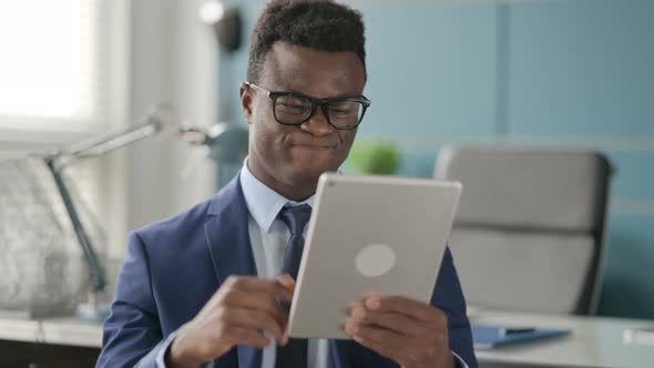 Portrait of African Man Having Loss on Tablet in Office