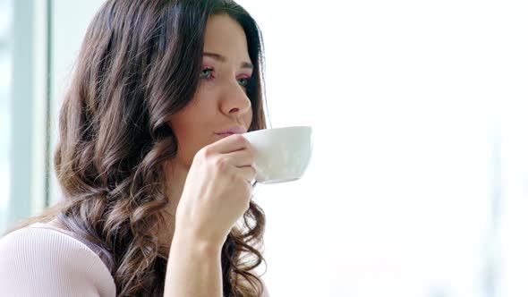 Young girl drinking a coffee