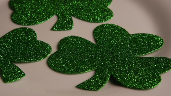 Rotating stock footage shot of St Patty's Day clovers on a white surface - ST PATTYS 008