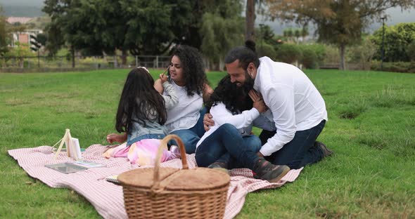 Indian parents having fun at city park playing with their children - Family, summer and love