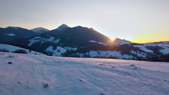 Colorful Sunset over Mountains in Winter Landscape