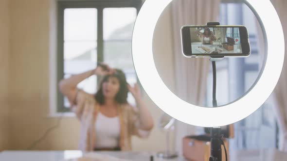 Caucasian blogger woman doing a video at home