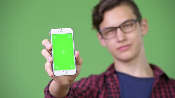 Young Handsome Teenage Nerd Boy Showing Phone