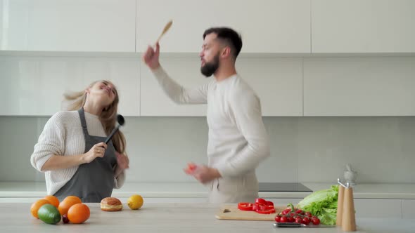 Happy Couple in Love is Having Fun in the Kitchen Dancing Together Moving to Their Favorite Music