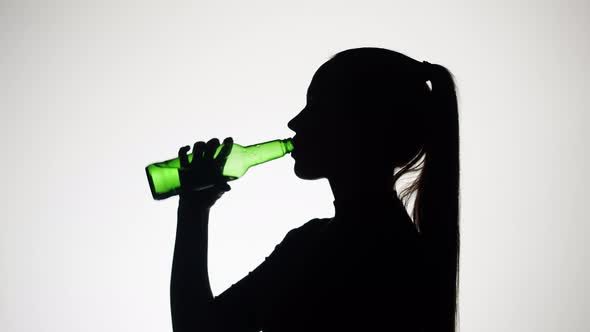 Woman Drinking Beer on White Background