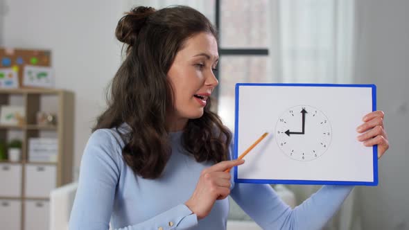 Teacher with Clock Having Online Class at Home