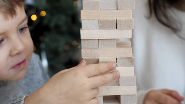 Family Is Playing in Wooden Tower at Home