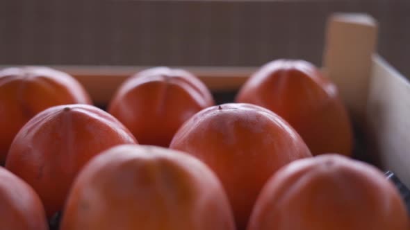 Ripe Delicious Persimmon Packaged in a Box Closeup