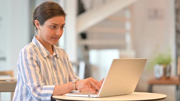 Tired Young Latin Woman with Laptop Having Back Pain at Home