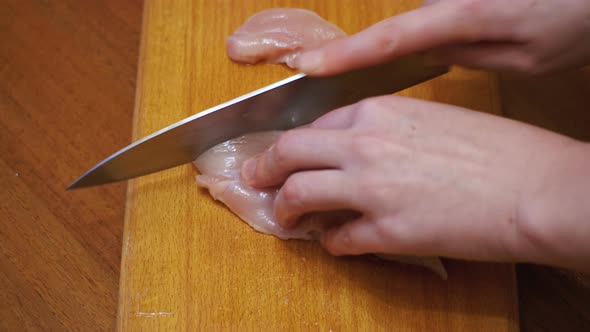 Hands Cutting Fresh Meat, Cutting Meat on a Kitchen Board, Cutting Raw Meat