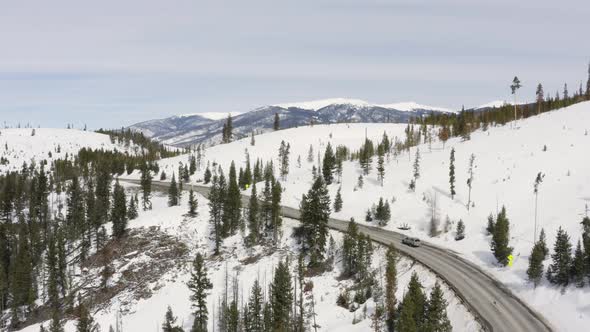 Grey Truck Traveling Along Mountain Road Winter Snow Aerial Birds Eye Drone View