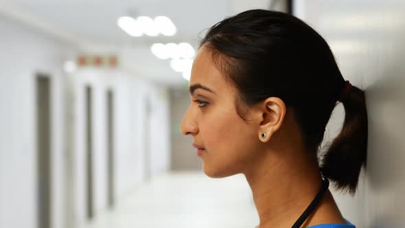 Portrait of female doctor standing in corridor