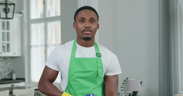 Black-Skinned Worker of Cleaning Company Posing on Camera while Cleaning 