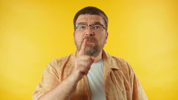 Bearded man in yellow shirt on bright background. People lifestyle concept.