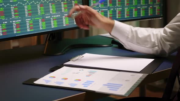 Close Up of Stock Broker Taking Notes on Clipboard