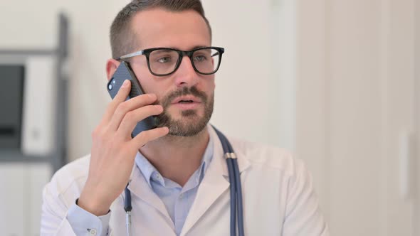 Portrait of Male Doctor Talking on Smartphone