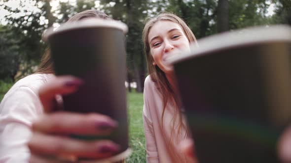 Happy Friends Having Picnic Outdoor Laughing Happily Chatting and Toasting with Paper Cup of