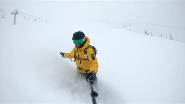 ACTION: A snowboarder rides through deep snow and turns in the fresh powder.